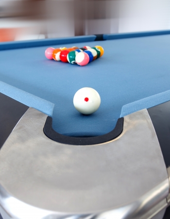 Fifteen billiard spheres lay on blue cloth