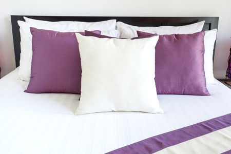 Luxury room setting with bed and pillowsの写真素材