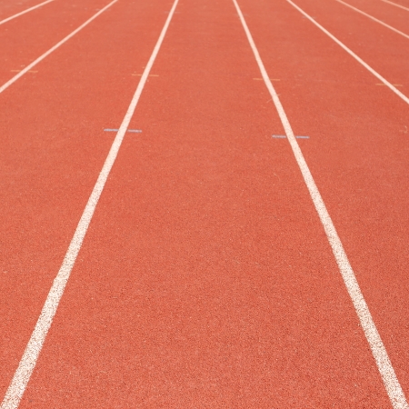 Lanes of a red race track in the stadiumの写真素材
