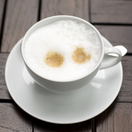 Coffee cup with milk on the tableの写真素材