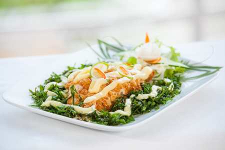 Fish dish - fried fish fillet with vegetables の写真素材