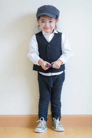 Little girl playing to be a police and holding a pistolの写真素材