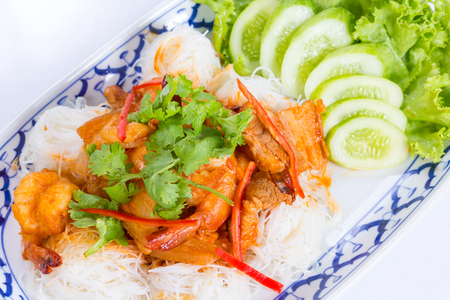 Rice noodles with pork, shimp and vegetable on white backgroundの写真素材