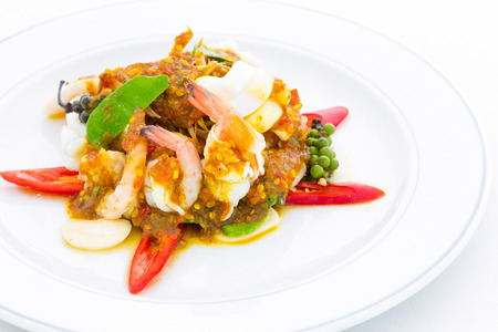 Sautéed shrimp with fresh peppers on white plateの写真素材