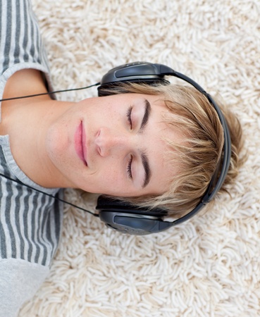 Teen guy listening to musicの写真素材