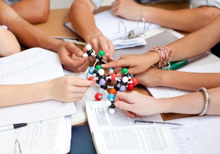 Close-up of teenagers studying molecules in a libraryの写真素材