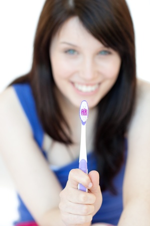 Pretty woman holding a toothbrush の写真素材