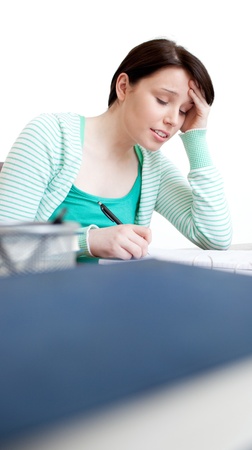 Exhausted student doing her homework の写真素材