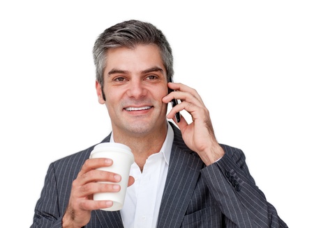 A businessman talking on phone and drinking coffeeの写真素材