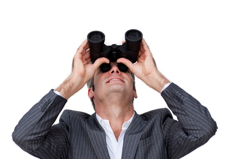 Happy businessman looking through binoculars の写真素材