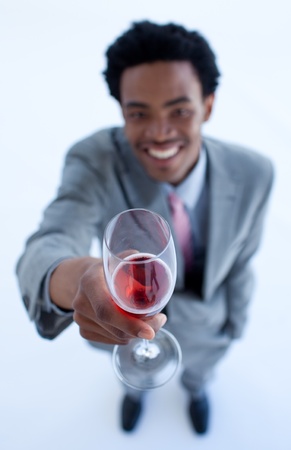 Afro-American businessman celebrating a success with wineの写真素材