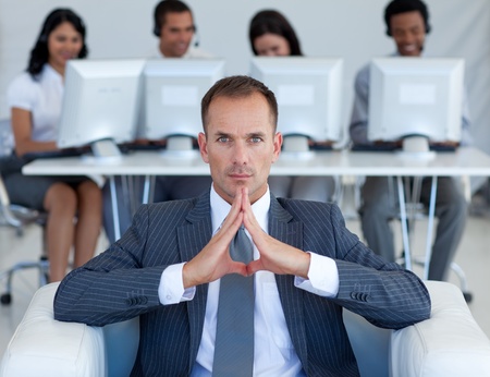 Serious manager sitting in call centerの写真素材