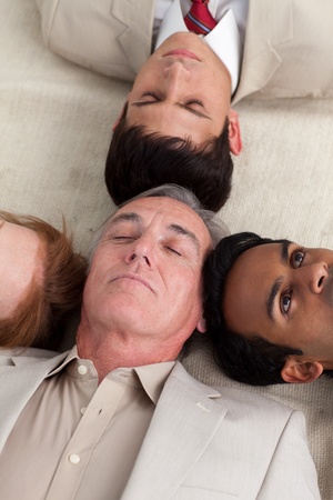International Business team lying on the floor の写真素材