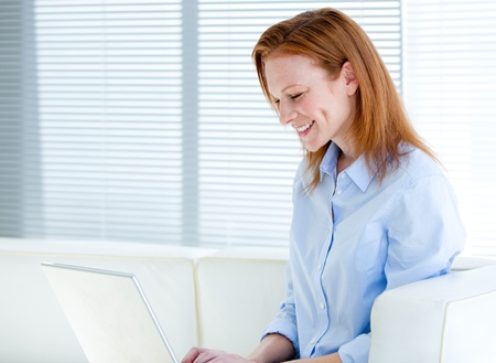 Happy business woman working on a laptop computer の写真素材
