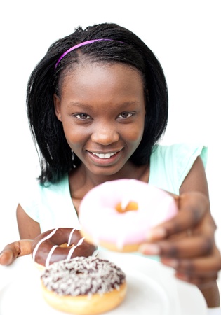 Pretty young woman holding a donut の写真素材