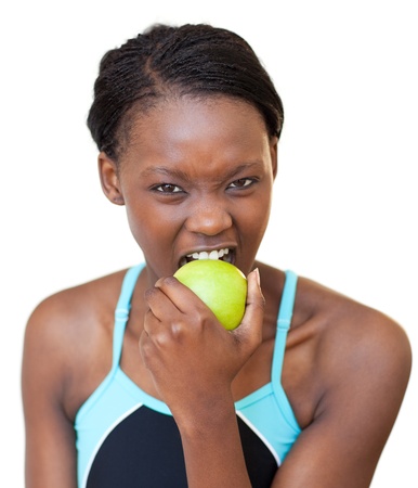 Cheerful fitness woman eating an appleの写真素材