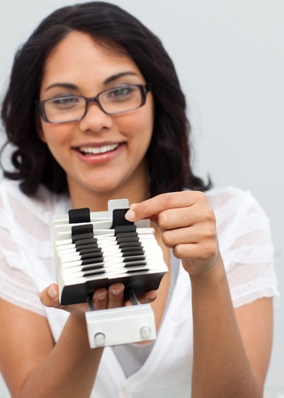 Smiling ethnic businesswoman searching for an indexの写真素材