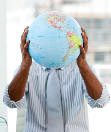 Afro-american businessman holding a terrestrial globeの写真素材