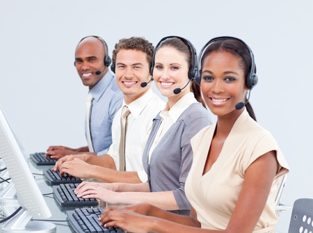 Multi-ethnic customer service representatives using headsetの写真素材