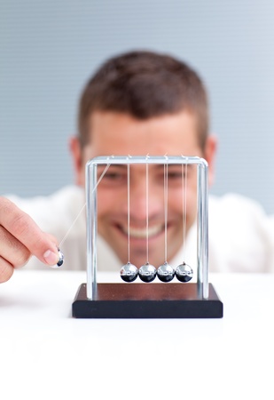 Businessman moving Newton ballsの写真素材