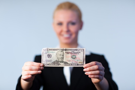 Business woman holding up dollars 