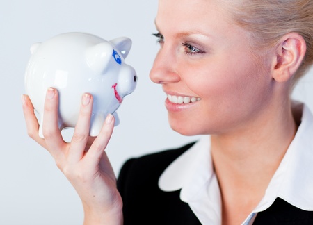Young business woman holding a piggy Bankの写真素材