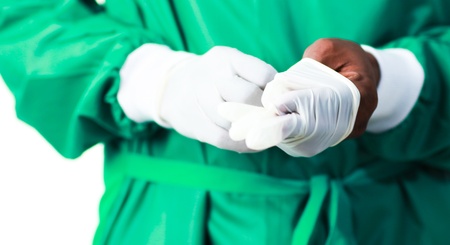 Surgeon putting on his glovesの写真素材