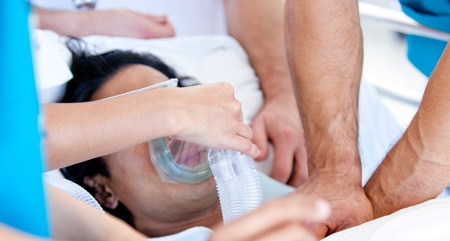 Medical team giving oxygen mask to the patient