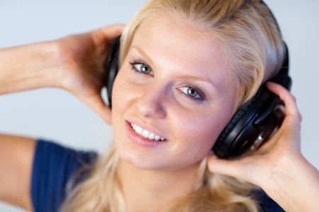 Blonde woman listening music with headphones の写真素材