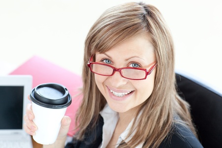Beautiful businesswoman drinking coffee の写真素材