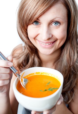 Positive woman holding a soup bowl の写真素材