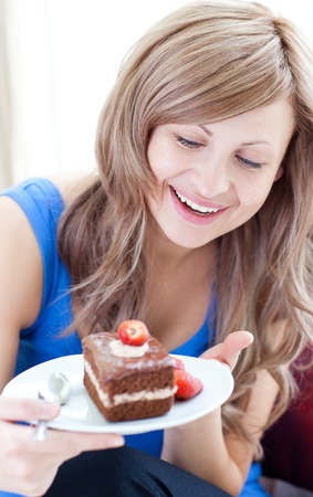 Happy woman holding a piece of chocolate cakeの写真素材
