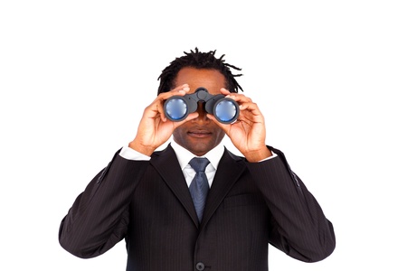 Handsome afro-american businessman holding binoculars upwards の写真素材