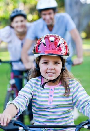 Cute little girl riding a bike の写真素材