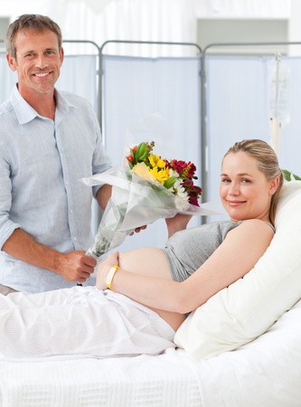 Pregnant young woman on a hospital bedの写真素材