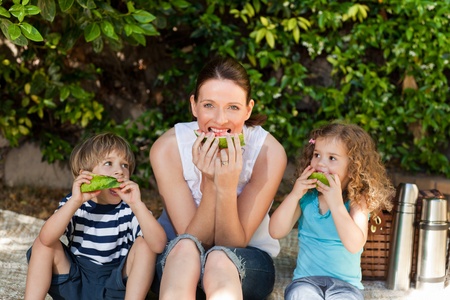 Happy family picnicking in the garden の写真素材