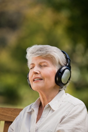 Elderly woman listening to some musicの写真素材