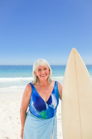 Mature woman with her surfboardの写真素材