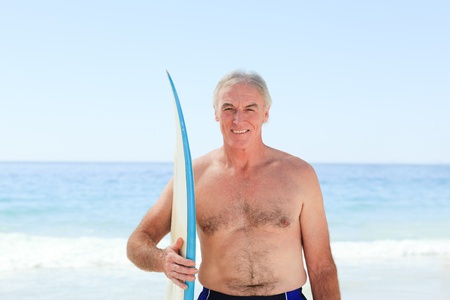 Retired  man with his surfboardの写真素材