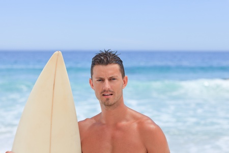 Man posing with his surfboard