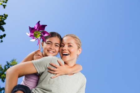 Mother and her daughter with a windmillの写真素材