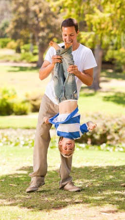 Father playing with his son  in the parkの写真素材