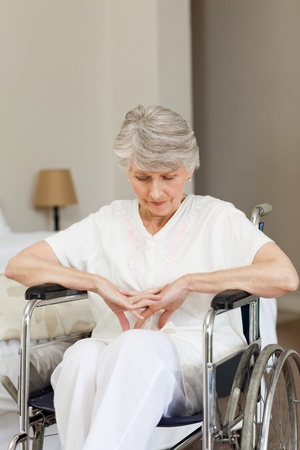 Senior woman asleep in her wheelchair at homeの写真素材