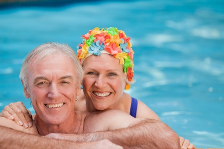 Happy mature couple in the swimming pool の写真素材