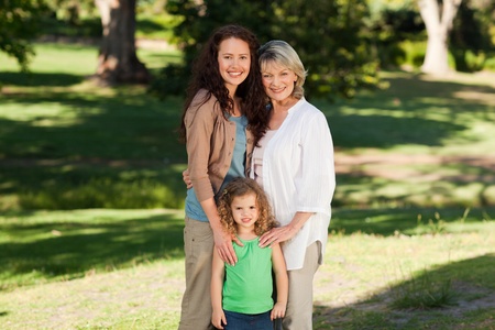 Smiling family looking at the camera in the parkの写真素材