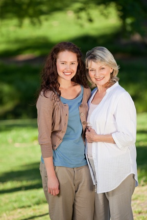 Mother with her daughter looking at the camera in the parkの写真素材