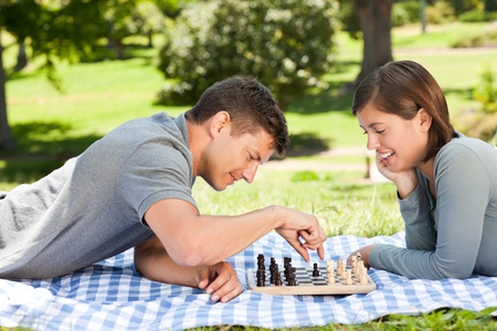 Couple playing chess in the parkの写真素材