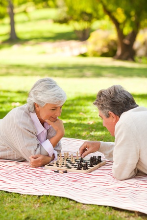 Elderly couple playing chessの写真素材