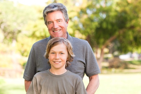 Grandfather with his grandson in the park
