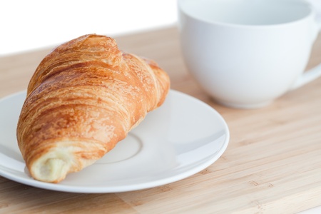 Breakfast with coffee and croissants on a white backgroundの写真素材